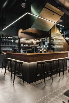 an empty bar with stools in front of it