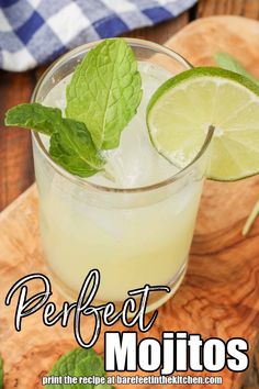 a mojito cocktail with mint garnish and lime on the rim, sitting on a cutting board