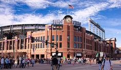 a crowd of people walking around a baseball stadium