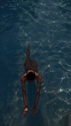 a person floating in the water with their feet up and head above the water's surface