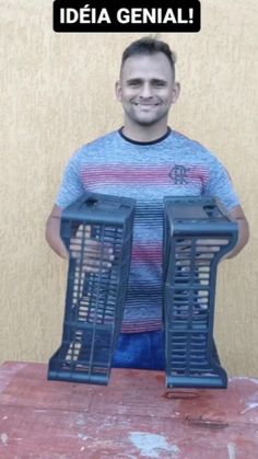 a man holding two large bird cages with the words idea genial on it in front of him