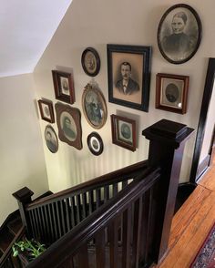 a staircase with many framed pictures on the wall