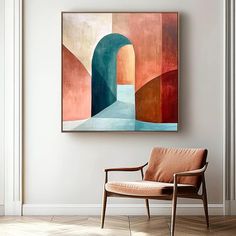 an abstract painting hangs on the wall above a chair in a room with hardwood floors