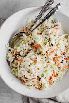 a white bowl filled with coleslaw and carrots