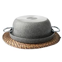 a large gray pot sitting on top of a wooden tray