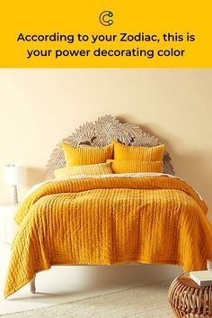 a bed with yellow bedspread and pillows in a bedroom next to a wicker basket