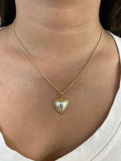 "18 Karat Gold Filled Pearl Heart Charm Necklace The perfect addition to layering with other 14\" or 16\" inch dainty gold chains. An elegant, simple piece that transitions well for daily wear. Material: 18 Karat Gold Filled, Hypoallergenic, Tarnish Resistant. Pendant Size: 17mm x 18mm (without bail) Chain Length: 18 inches Proper Care for your new MaLiBeads: Gold Filled products are durable; however, please remember to apply beauty products such as perfume, hairspray or deodorant before wearing Heart Necklace With Pearl Chain For Gift, Heart Pendant Pearl Necklace With Clavicle Chain As Gift, Pearl Clavicle Chain Necklace With Heart Pendant As Gift, Gold Heart Necklace With Pearl Pendant For Valentine's Day, Gold Pearl Necklace With Heart Charm For Anniversary, Valentine's Day Gold Heart Necklace With Pearl Pendant, Heart Shaped Pearl Pendant Necklace For Mother's Day, Gold Pearl Necklace With Heart Charm For Valentine's Day, Heart Pendant Pearl Necklace For Valentine's Day