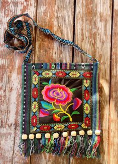 This is a lovely gift for any occasion or to add to your own collection. * Embroidery Design * Wooden Beads to add style * Crossbody * Cambaya and Polyester Fabric * Beautiful Bold Colors * Zipper Closure * Floral Design * Tassels attached at the bottom of bag Bohemian Multicolor Embroidery Bags As Gifts, Festival Bags With Multicolor Embroidery And Beaded Details, Festival Bags With Multicolor Embroidery And Beads, Festival Beaded Bags With Multicolor Embroidery, Festival Multicolor Embroidered Beaded Bags, Embroidered Green Shoulder Bag As Gift, Embroidered Green Shoulder Bag For Gift, Embroidered Square Shoulder Bag For Gift, Bohemian Beaded Bag As Gift