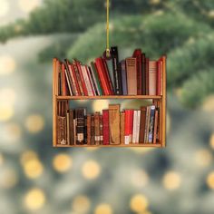 a bookshelf filled with lots of books on top of a wooden shelf next to a tree