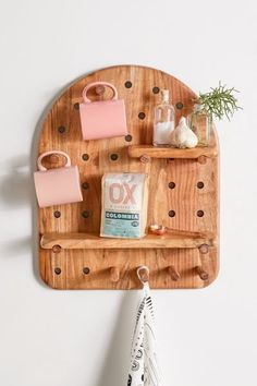 a wooden shelf with various items on it and a towel hanging from the wall next to it