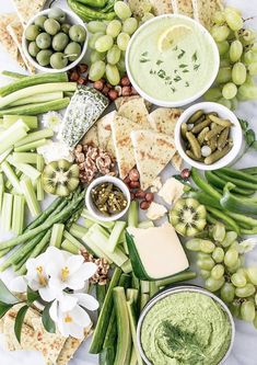 a table topped with lots of different foods and dips on top of each other