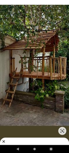 a tree house built into the side of a building with stairs leading up to it