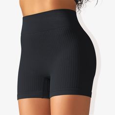 The Anna-Kaci Women's Wide Band Stretchy Rib Knit Seamless Gathered Biker Shorts are a must-have for your activewear collection. These shorts feature a wide band that offers a secure and comfortable fit, enhancing your silhouette with shaping seams. Made from stretchy rib knit fabric, they provide excellent flexibility and movement while maintaining a seamless construction for a smooth, irritation-free experience. The gathered detail adds a touch of style, making these biker shorts perfect for w Black Fitted Seamless Bottoms, Elastic Seamless Solid Color Biker Shorts, Fitted Black Bottoms With Seamless Design, Black Seamless Mid-thigh Biker Shorts, Black Compression Seamless Shorts, Compression Seamless Black Shorts, Elastic Seamless Biker Shorts, Black Seamless Stretch Biker Shorts, Black Stretch Seamless Shorts