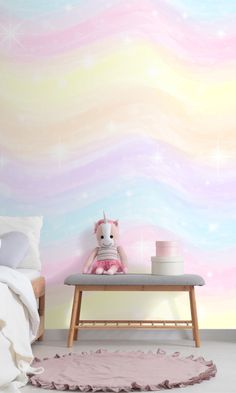 there is a pink and blue wall in this room with a unicorn on the bench