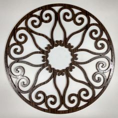 a circular metal wall decoration on a white wall