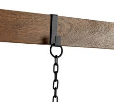 a close up of a wooden beam with chains hanging from it's sides and a metal chain attached to the end