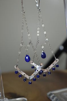 "These Gorgeous Lapis Lazuli Chandelier Earrings display hand formed components against Beautiful Royal Blue Gemstone beads. These Earrings are displayed in Sterling Silver; they are also available in 14k Rose Gold Fill and 14k Gold Fill. These Earrings add a touch of beauty to your \"Everyday\" but will carry you into your Evening or Special Occasion! Lapis Lazuli is an alternate birthstone for the month of December and serves as the 9th Anniversary Precious Stone gift. As a healing stone, Lapi Elegant Hand Forged Blue Earrings, Blue Sterling Silver Jewelry For Celebration, Blue Dangle Chandelier Earrings For Anniversary, Celebration Blue Sterling Silver Jewelry, Sterling Silver Chandelier Earrings For Celebration, Nickel-free Dangle Chandelier Earrings For Anniversary, Blue Dangle Chandelier Earrings For Celebration, Sterling Silver Dangle Jewelry For Celebrations, Artisan Sterling Silver Jewelry With Dangling Beads