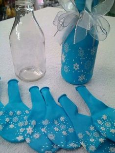 blue snowflakes are sitting next to some glass bottles