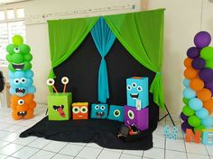 an assortment of decorations and balloons for a birthday party with monsters on the front wall