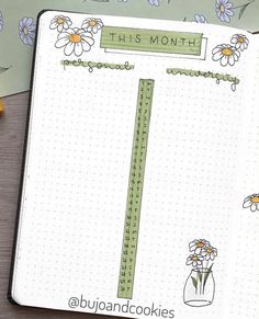 an open planner with flowers on it and the words this month written in cursive writing