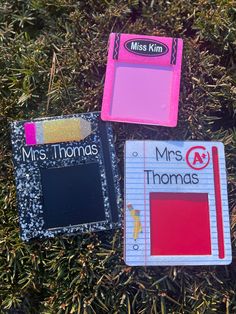 three magnets that say mrs thomas, mrs thomas and mr thomas on them in the grass