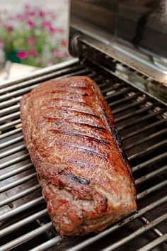 a piece of meat is cooking on the grill