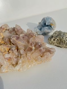 three different types of rocks on a white surface with one rock next to the other