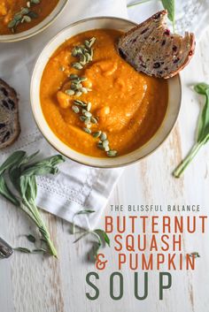 two bowls of butternut squash and pumpkin soup on a white wooden table with bread