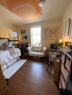 a bedroom with bunk beds, desk and chairs