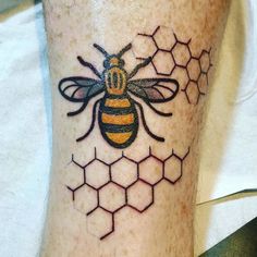 a bee with honeycombs on its legs is seen in this tattoo photo taken by the owner