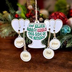 an ornament hanging from a christmas tree on a table with ornaments around it