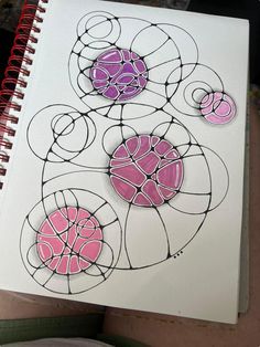 a drawing with pink and black circles on white paper