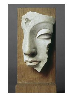 a white mask on top of a wooden block