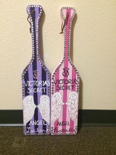 two wine bottle shaped like angel tags with the words victoria's secret written on them