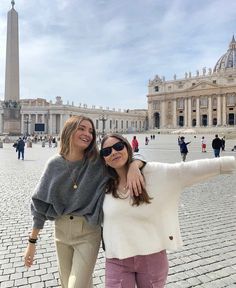 two women taking a selfie in front of the monument