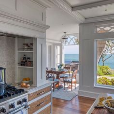 an open kitchen and dining room area overlooking the ocean