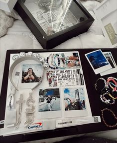 an assortment of jewelry and bracelets on display in a black box next to other items