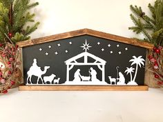 a nativity scene is displayed on a mantle