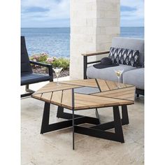 a coffee table sitting on top of a stone floor next to a couch and chair