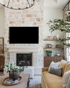 a living room filled with furniture and a flat screen tv mounted on the wall above a fireplace