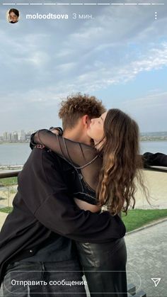 a man and woman kissing on the beach