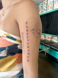 a woman with a tattoo on her arm that says perseverance