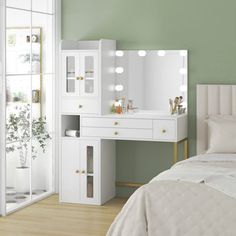 a bedroom with a white vanity, mirror and lights on the wall next to a bed