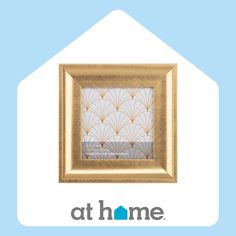 a gold frame with an art home logo in the center on a light blue background