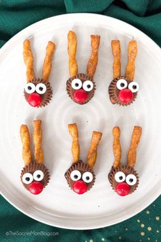 some pretzels with reindeer noses are on a plate