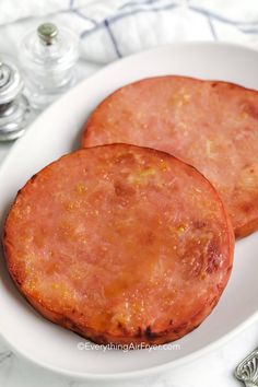 two sausage patties on a white plate