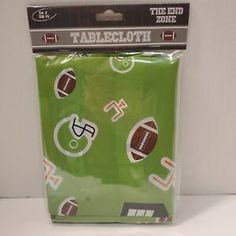 the end zone tablecloth with footballs on it in green and white packaging,