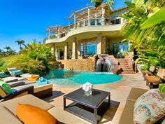 an outdoor living area with couches, chairs and a pool