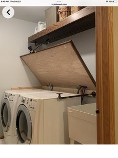 a washer and dryer sitting in a room next to a shelf with baskets on it