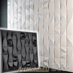 the wall is made out of white paper and has wavy lines on it, as well as an abstractly designed pattern